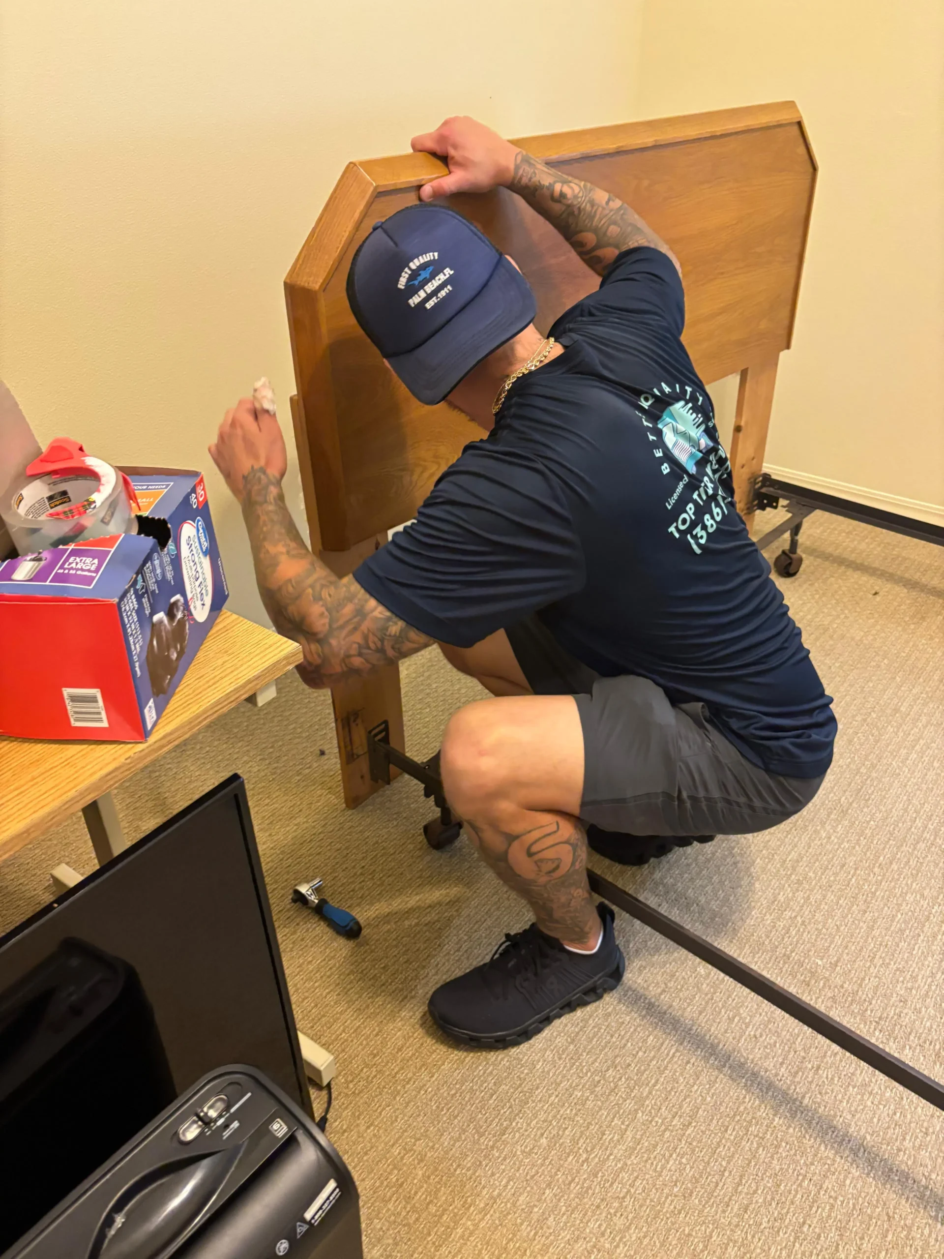 Mover assembling wooden bed frame.